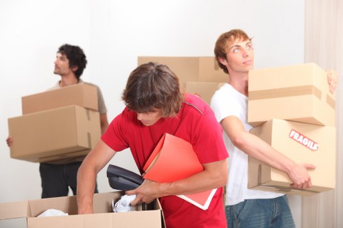 Boxes and furniture being loaded into a local removals van