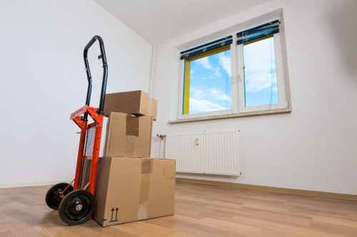 Professional movers loading items for a Brent home relocation